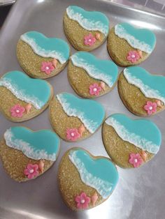 decorated cookies in the shape of hearts on a baking sheet