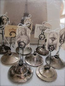 a group of silver bells sitting on top of a table next to an old photo