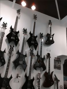 black and white photograph of guitars hanging on the wall