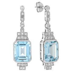 Express yourself with these insanely stylish, stunningly detail earrings with emerald cut blue topaz and diamonds in 9k white gold. Match them with your favorite outfit to complete your look. Information Style: Art Deco Metal: 9K White Gold Width: 9 mm. Length: 32 mm. Weight: 5.34 g. (approx. in total) Backing: Push Back Gemstones I Type: Blue Topaz Shape: Emerald Cut Size: 10 x 8 mm. Number: 2 Weight: 8.20 Carat (approx. in total) Gemstones II Type: Diamond Shape: Round Average Color: H Average Luxury Art Deco Topaz Jewelry, Art Deco Metal, Style Art Deco, Sparkly Jewelry, Earring Box, Art Deco Stil, Estilo Art Deco, Deco Jewelry, Drop Earring