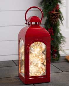 a red lantern with christmas lights on it