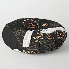 a black floor pillow with gold and white designs