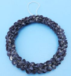 two strands of purple beads on a blue background with a white string in the middle