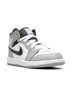 White/black/grey leather Air Jordan 1 Mid sneakers from Jordan Kids featuring signature Air Jordan Wings logo, signature Swoosh logo detail, contrasting panel detail, round toe, front lace-up fastening, logo patch at the tongue, ankle-length, branded insole and rubber sole. These styles are supplied by a premium sneaker marketplace. Stocking only the most sought-after footwear, they source and curate some of the most hard to find sneakers from around the world.. | Jordan Kids Air Jordan 1 Mid sn Boys Jordan Shoes, Nike Boys Shoes, Snicker Shoes, Gray Nike Shoes, Jordan Wings, Kids Jordan, Sneakers For Boys, Grey Jordans, Mid Sneakers