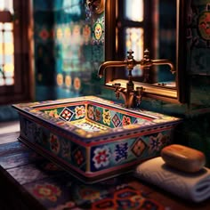 a colorful sink in the middle of a room with stained glass windows and decorative tiles on the walls