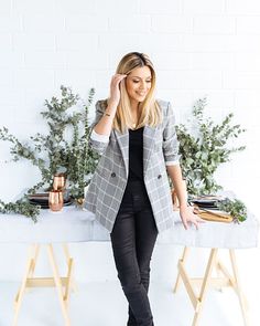 a woman standing in front of a table