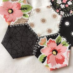 four pieces of fabric with flowers and dots on them, all in different shapes and sizes