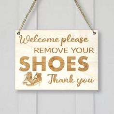 a wooden sign that says, welcome please remove your shoes thank you