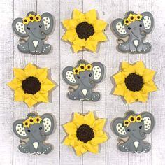 cupcake toppers with sunflowers and an elephant in the middle on a white wooden background