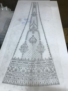 an intricately designed piece of paper on top of a table