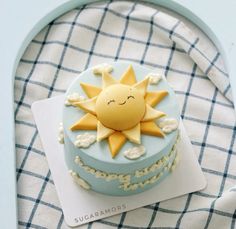 a blue cake with a yellow sun on top