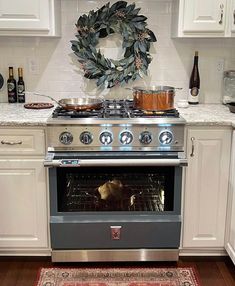 an oven with a wreath on the wall above it