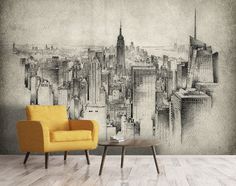 a chair and table in front of a wall with a cityscape on it