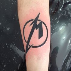 a black and white photo of a lightning bolt tattoo on the left arm with a circle around it