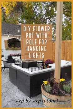 an outdoor patio with potted plants and hanging lights on the post in front of it