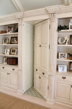 a large white bookcase in the corner of a room