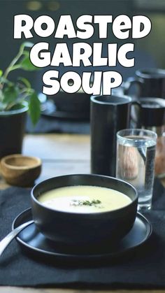 roasted garlic soup in a bowl on a black plate with the words roasted garlic soup above it