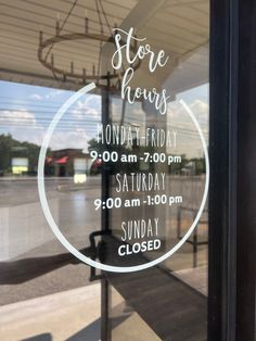 a store hours sign in the window of a building