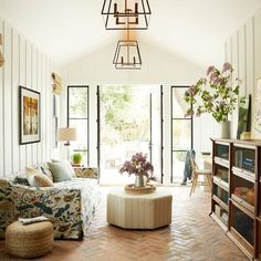 a living room filled with furniture and lots of windows