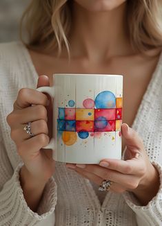 a woman holding a coffee mug in her hands