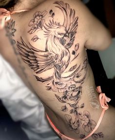 a woman with a bird tattoo on her back