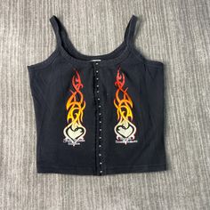 Vintage 2000s Sturgis South Dakota Flames Motorcycle Biker Summer Spring Black Button Up Tank Top Extra Large Women Condition:  Excellent Used Condition  = No Flaws Measurements: Please see photos above for all measurements IF YOU BUY TWO OR MORE ITEMS USE THE CODE BUNDLE @ CHECK TO SAVE 20% WE SHIP WITHIN 24 HOURS AFTER PURCHASE! Please be aware that we do not offer free returns!! The Buyer is responsible for the cost of the return label.  Follow us on TikTok & Instagram @findsnostalgic and tag us in your finds Edgy Black Top With Buttons, Edgy Black Tops With Button Closure, Vintage Black Tops With Snap Buttons, Y2k Cotton Tops With Button Closure, Edgy Fitted Tops With Button Closure, Sturgis South Dakota, Button Up Tank Top, Lover Girl, Vintage 2000s