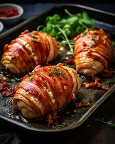 bacon wrapped chicken on a baking sheet with garnishes