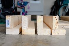 three pieces of wood sitting on top of a table next to each other in front of a bike