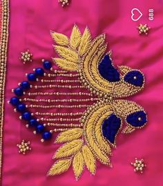 an embroidered pink jacket with gold and blue details