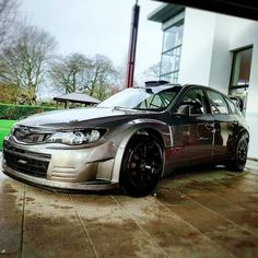 a silver car parked in front of a building