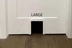 a white dog house with the word large written on it's door and floor