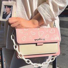 The Epiphany Bag, capturing the essence and inspiration of Jin's solo song of the same name, is an adorable addition to the LY Set, designed with the same charming hearts adorning the Epiphany wallet and lanyard. The bag is set in a lovely pink color reminiscent of Jin's sweet aesthetic. DESCRIPTION Made of soft PU leather material Pink color with cream highlights Adorned with silver metal "epiphany” logo Dimensions: 8.5 inches x 6 inches x 2 inches Comes with chain and adjustable strap All By E Pink Satchel Bag For Valentine's Day, Pink Bags For Everyday And Valentine's Day, Everyday Pink Bags For Valentine's Day, Pink Shoulder Bag With Adjustable Strap - Gift, Cute Valentine's Day Crossbody Shoulder Bag, Valentine's Day Pink Bags With Adjustable Strap, Pink Portable Shoulder Bag As Gift, Pink Crossbody Bag For Valentine's Day, Valentine's Day Rectangular Shoulder Bag With Removable Pouch