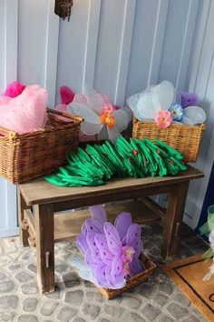 some baskets and flowers on a table outside