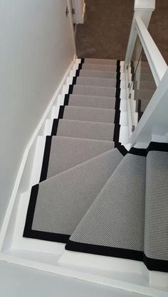 the stairs in this house are painted gray and white with black trimmings on them