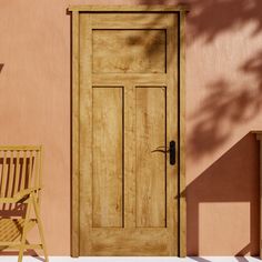 a wooden door sitting next to a chair on top of a floor near a pink wall