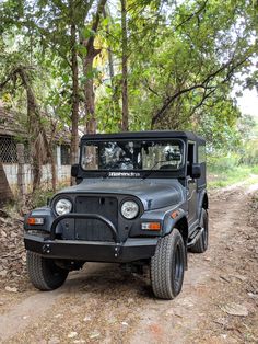 a black jeep driving down a dirt road