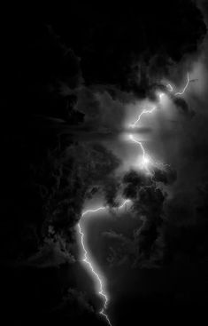 black and white photograph of lightning striking through the clouds