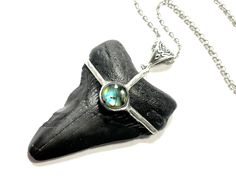 This listing is for the exact pendant pictured above. It is a beautiful fossilized Megalodon or Mako Shark tooth that has a beautiful flashy rainbow moonstone.  It is pictured with a 24" stainless steel chain, but I have many other chain options available.   All jewelry ships in a sturdy gift box, and will arrive ready for gift-giving. In Many cases, I can accommodate special or custom orders, simply message me, and I will do my best to help get you what you need, whether it's the perfect gift f Dainty Shark Tooth Necklace Smile The Ocean, Driftwood Pendant, Sand Tiger Shark Tooth Necklace, Shark Teeth Necklace, Shark Necklace Tooth, Men’s Shark Tooth Necklace, Mako Shark, Shark Tooth Necklace, Tooth Necklace