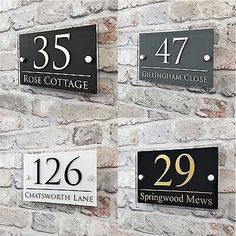 three black and white house numbers on a brick wall