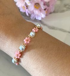 Prepare to blossom with our enchanting 14k Gold Filled Flower Beaded Bracelets! Beaded with Japanese glass seed beads, on strong nylon cord for long lasting wear. Add a pop of color and elegance to any summer outfits or casual wear😉🌸 Sparkling with all gold accents, this bracelet isn't just jewelry; it's a statement piece that radiates sophistication and charm. Wear these cute Pearl Flower bracelets with your cute bathing suites on the beach and summer dresses !👗 **This Listing is for 1 bracelet only** Sizing:  I would recommend 5 inches for children, teenagers and if you have petite wrists. I would recommend 6 inches for most adult wrists. Bracelet length (14k Gold Filled clasp to jump ring): 6''/15.24 cm Adjustable 14k Gold Fillled Extender: 2'' Total Length: 8''/20.32 cm  If you need Adjustable Delicate Beaded Bracelets With Flower Charm, Dainty Flower Pearl Beaded Bracelets, Adjustable Dainty Pearl Bracelet With Spacer Beads, Dainty Adjustable Pearl Bracelet With Spacer Beads, Adjustable Flower Pearl Bracelets, Adjustable Pearl Bracelet With Flower Shape, Adjustable Pink Pearl Bracelet With Flower Shape, Adjustable Flower-shaped Pearl Bracelets, Pink Beaded Dainty Pearl Bracelet