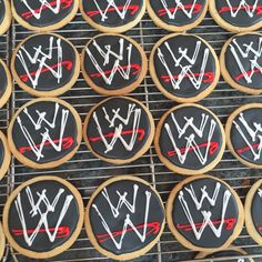 cookies decorated with white and red icing are on a cooling rack