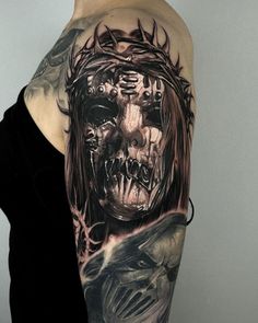 a woman's arm with a tattoo on it and a skull in the middle