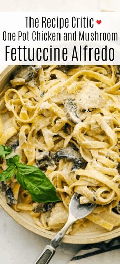 a plate of fettuccine alfredo with spinach and basil on the side