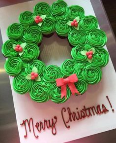 a green cupcake decorated like a christmas wreath