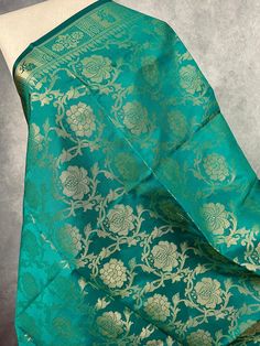 Gorgeous Rama Green Color floral Jaal Banarasi Dupatta with Muted Gold Zari Weave. Dupatta is Soft and will add beauty to any Outfit. Makes a Perfect Gift! Please note - Dupatta has black color tassles on the ends. Item: DupattaColor : Rama Green with Muted Gold Zari Weaving Fabric : Banarasi Silk (Non Pure Silk)Work : Zari Weaved with tassels Length of the dupatta : 88 inches (approx)Width of the dupatta : 35 inches (approx)Store Policies- No return or exchange will be accepted for color variat Green Banarasi Silk Traditional Wear For Celebrations, Green Traditional Wear With Dupatta For Festivals, Traditional Green Festival Wear With Dupatta, Festival Green Traditional Wear With Cutdana, Festival Traditional Wear In Green With Cutdana, Green Katan Silk Dupatta For Celebration, Green Banarasi Silk Dupatta For Celebration, Festive Green Jamawar Blouse Piece, Green Festival Saree With Traditional Drape