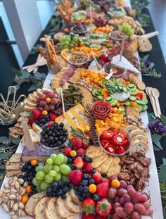 a long table filled with lots of different types of food and snacks on it's sides