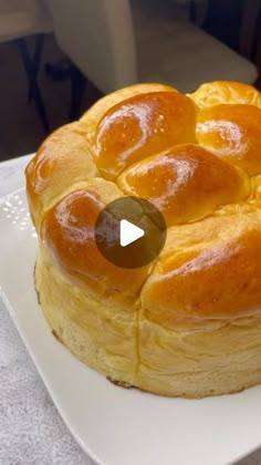 a white plate topped with a pastry on top of a table