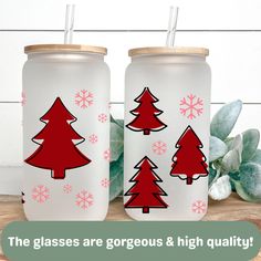 two red and white christmas trees painted on glass jars with the words, the glasses are gorgeous & high quality