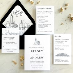 the wedding stationery is black and white with a city scene on it's front