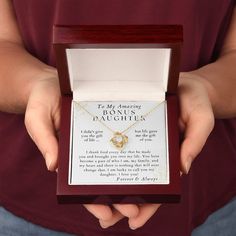 a person holding a birthday necklace in a box with the message happy birthday amanda written on it